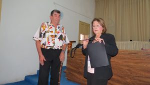 Maria Ibenez presents a S.A.M. wand to the Cuban Dean of Magic, Jose Ayra aka Mago Ayra, in asymbolic ceremonial gesture.